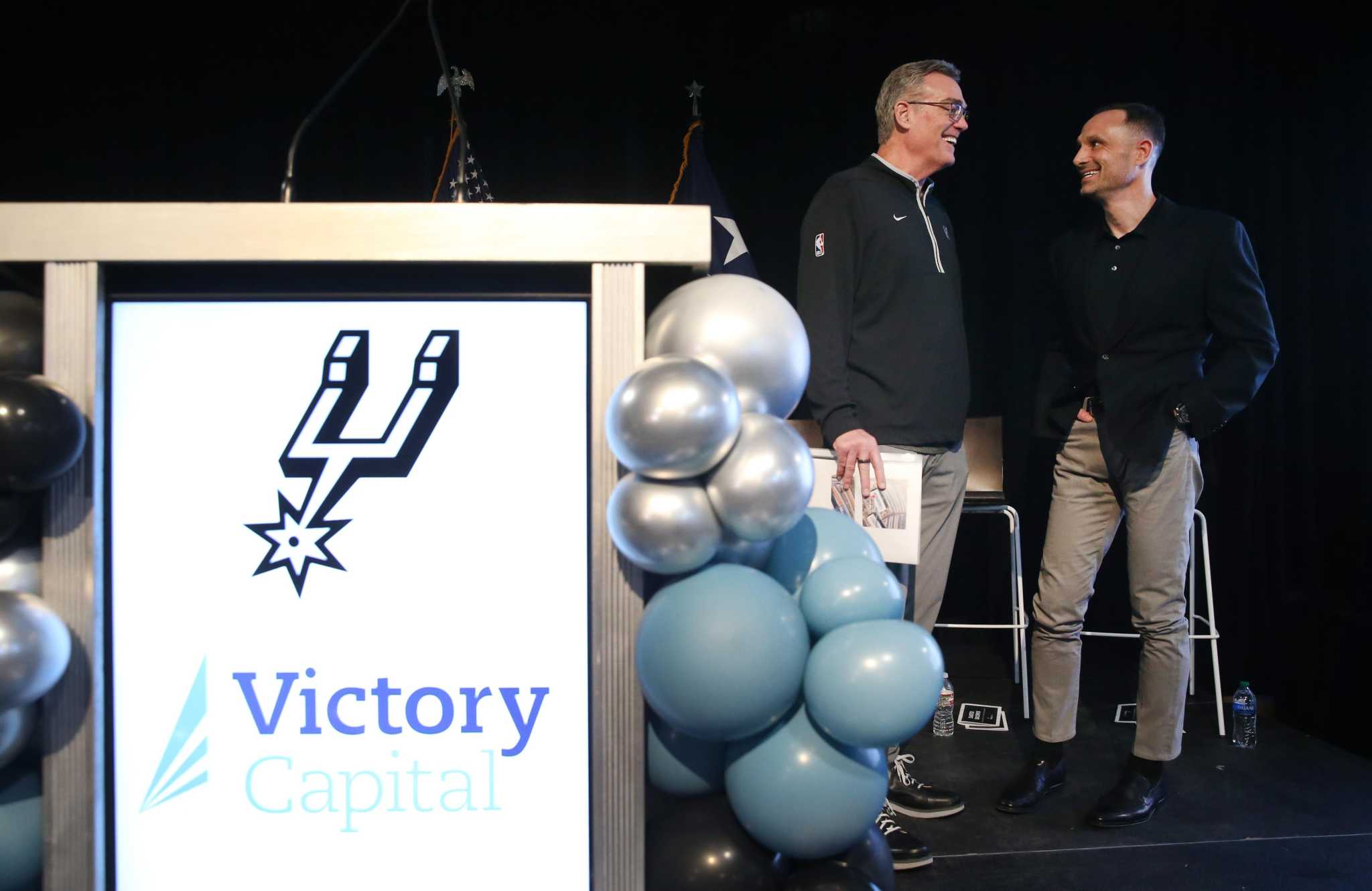 David C. Brown, right, with Spurs CEO R.C. Buford at the January 2023 partnership announcement