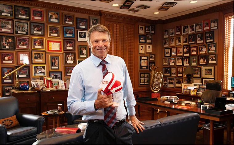 David Novak in his Yum! office, surrounded by employee recognition photographs on the walls and ceiling