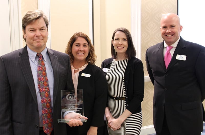 David Campbell at left holding his philanthropy award, with Wendi Spratt, Sarah Wells and Louis Fawcett