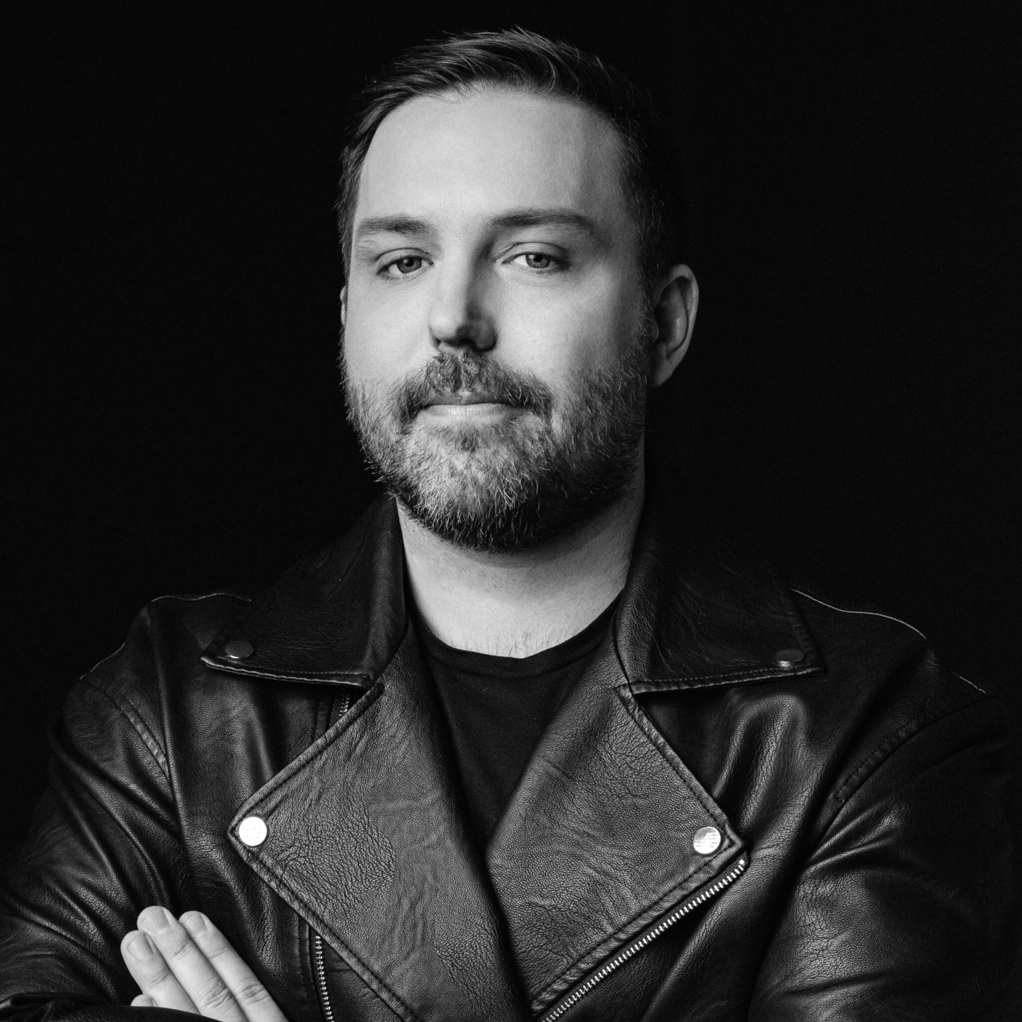David Campbell in a black leather jacket in a black-and-white press portrait