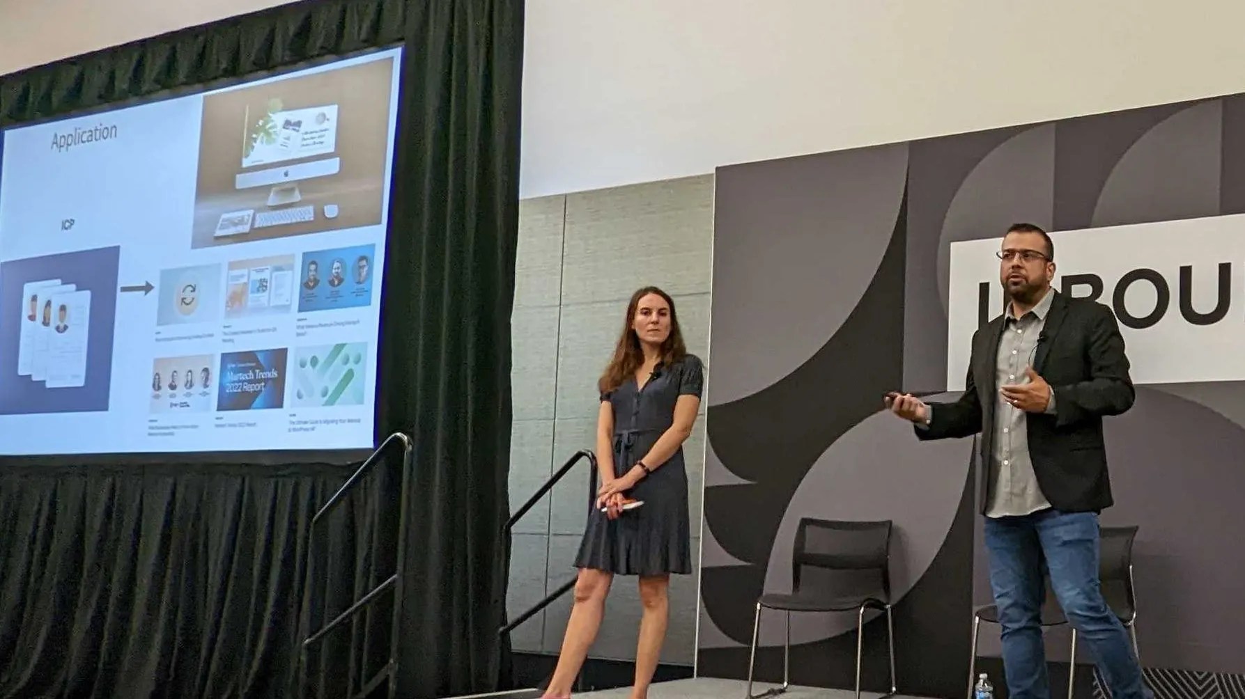 David Cardiel and Stephanie Schwartz presenting on a conference stage at HubSpot INBOUND