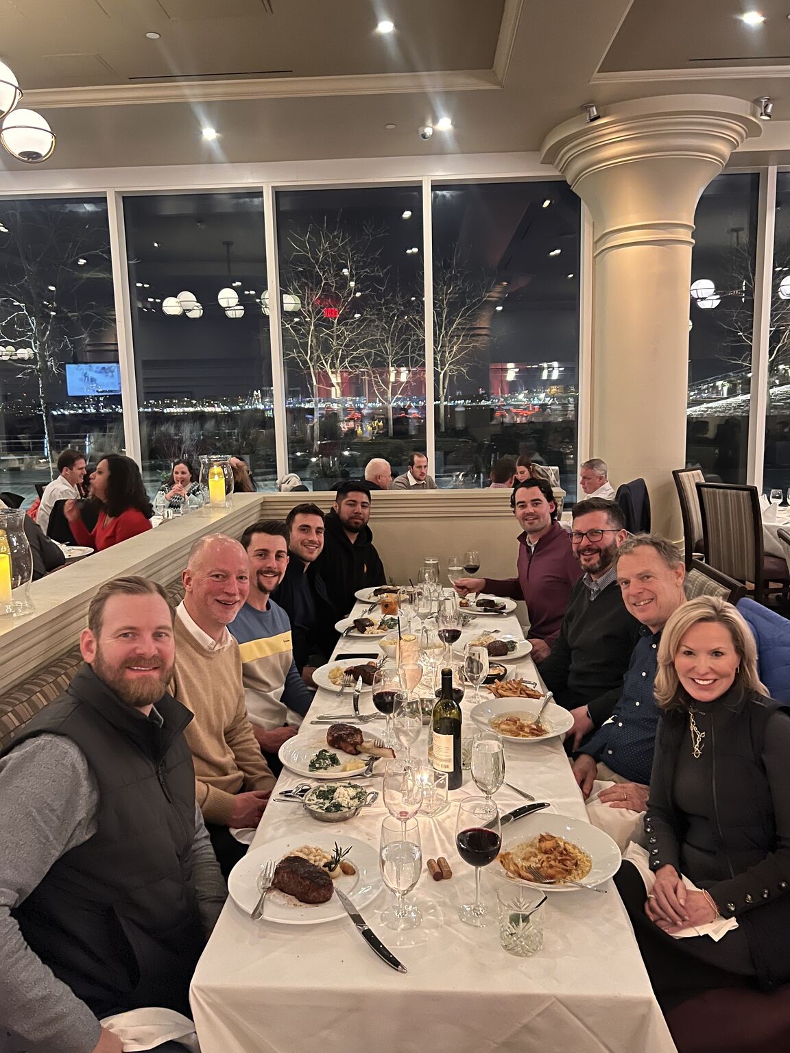 Collette Health colleagues, including David Fetterolf, seated around a restaurant table at a Boston team gathering