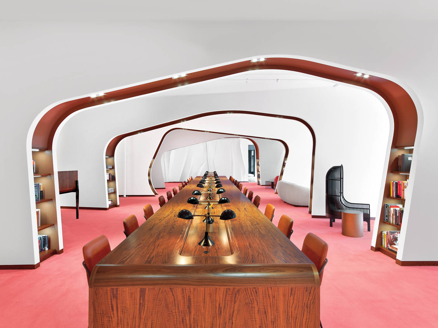 Dropbox’s San Francisco library with a long communal wooden table and repeated arches