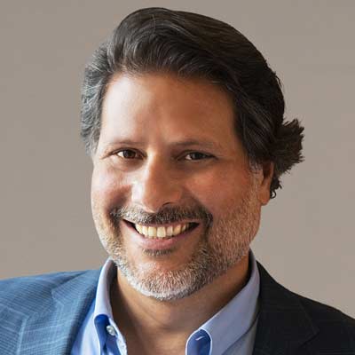 An archival corporate photograph of David Gentile in a blue jacket