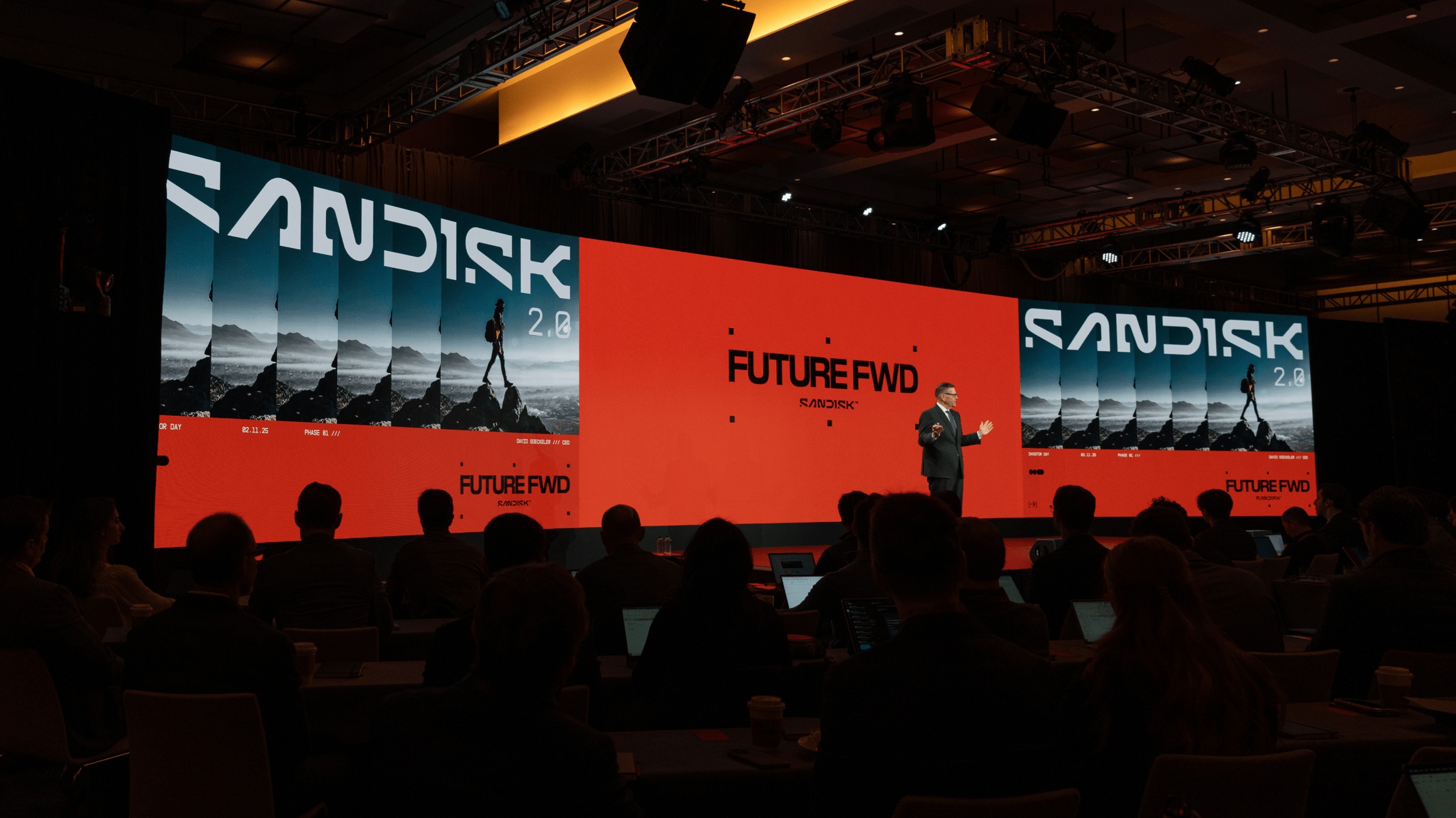 David Goeckeler presents Sandisk's Future FWD investor event on a red-lit stage