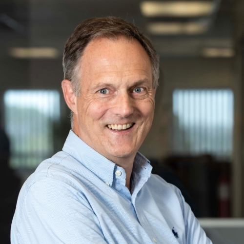 David Harding in a light blue shirt, in an office setting
