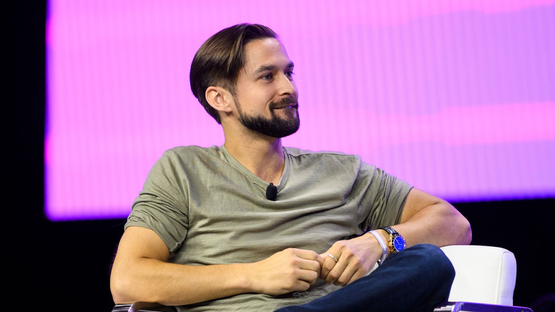 David Hoffman seated onstage at a crypto conference under purple lighting