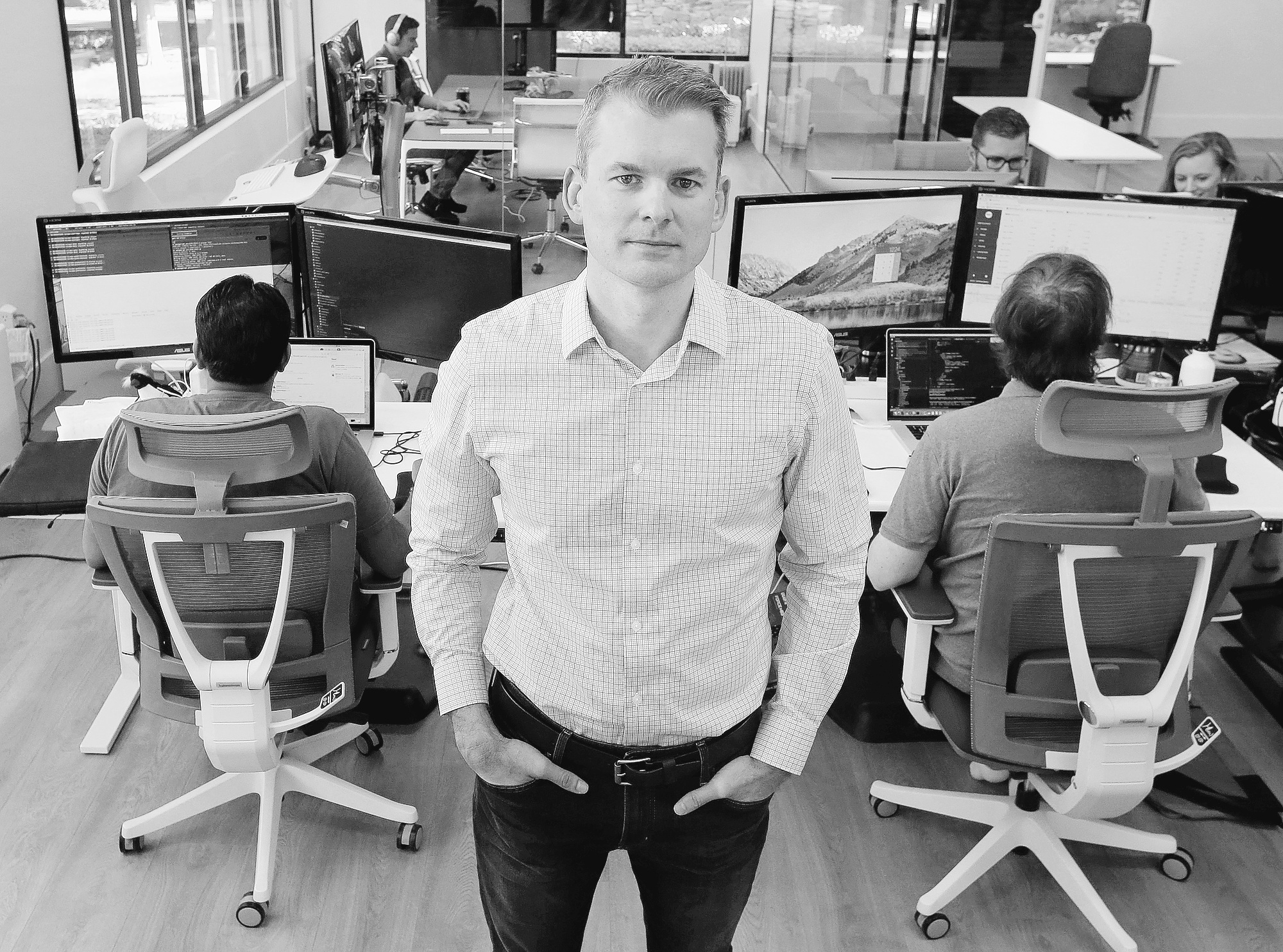 David Jackson standing among colleagues and computer workstations at FullStack’s Granite Bay office in 2018
