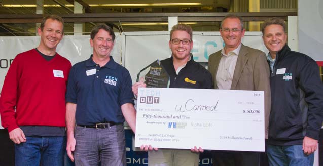 David Kozhuk at the center of a group holding uConnect’s $50,000 first-place check at TechOut 2014
