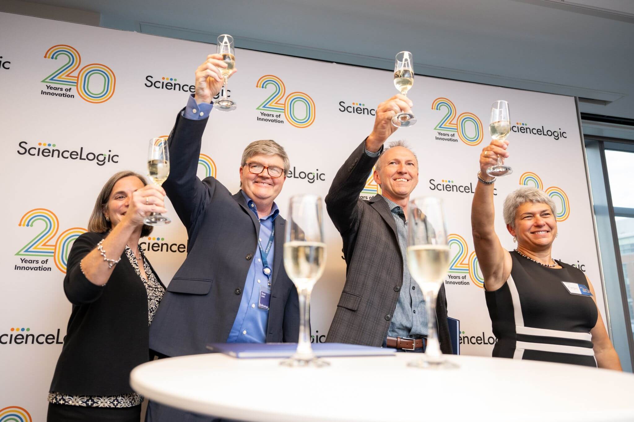 Guests raise glasses at ScienceLogic’s twentieth anniversary celebration