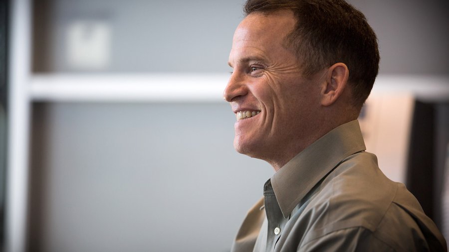 David Morken smiling during a conversation in an office