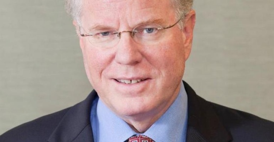 David Northington wearing glasses, a dark jacket and a patterned tie in a Contino press photograph