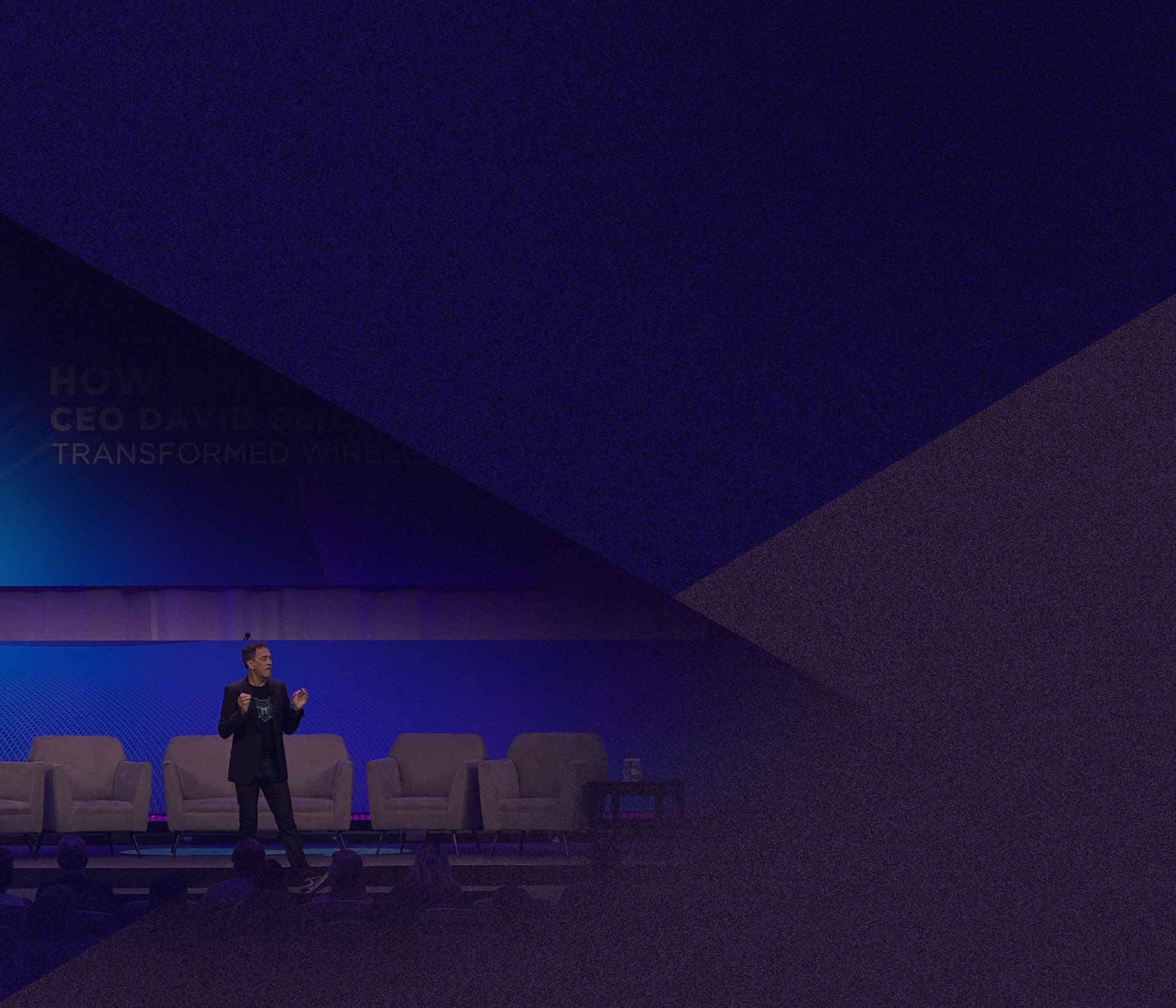 David Glickman speaking on a conference stage in a dark jacket and T-shirt