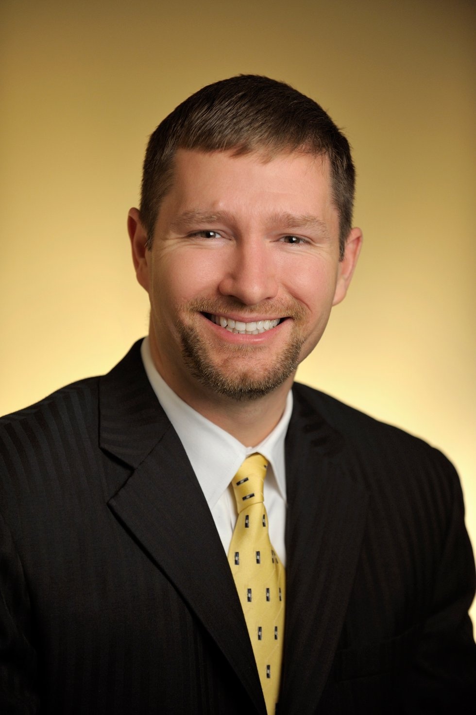 David Reeder in a dark suit and yellow tie in an archival Lexmark publicity photograph