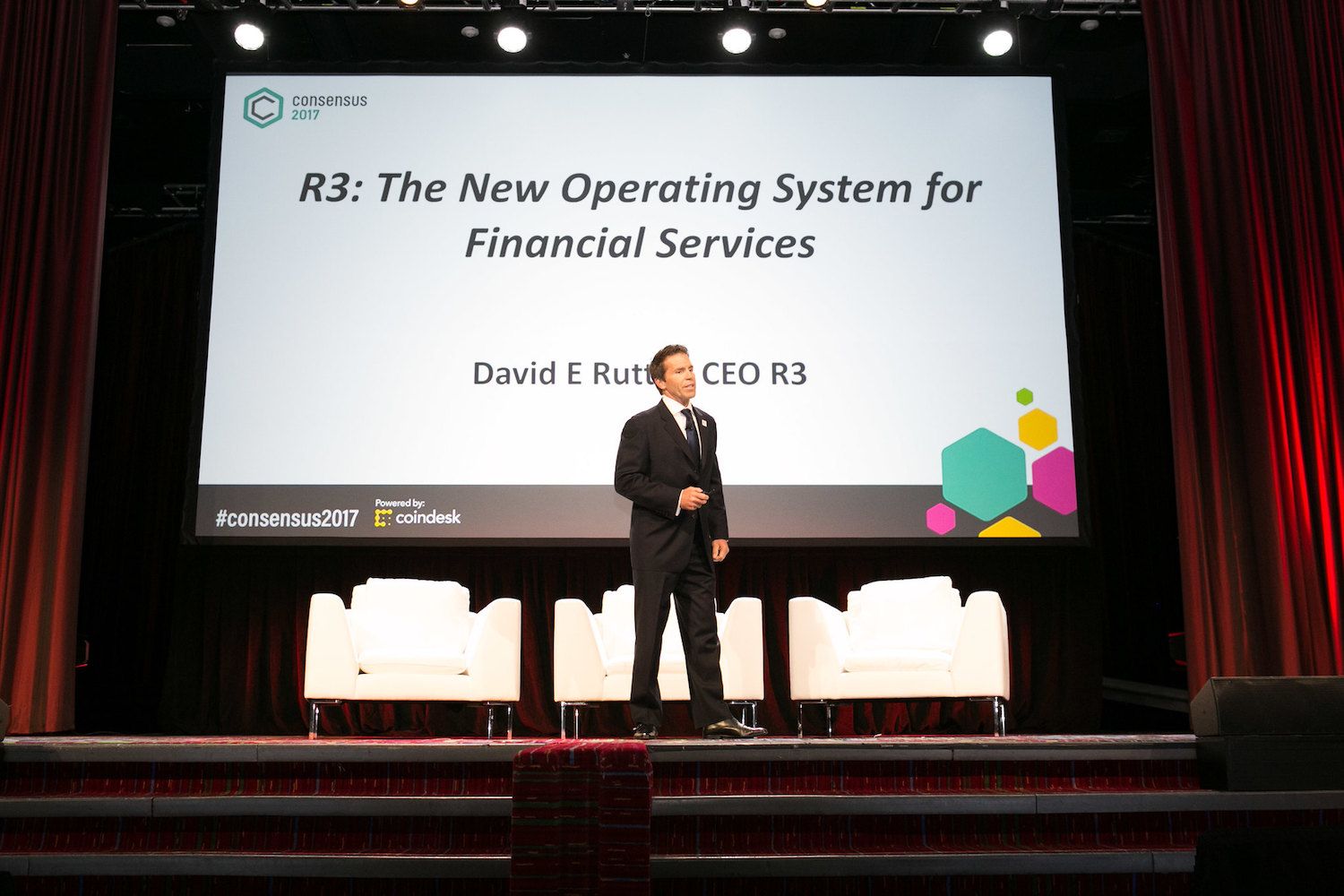 David E. Rutter speaking onstage at Consensus 2017, beneath a slide about R3 and financial services