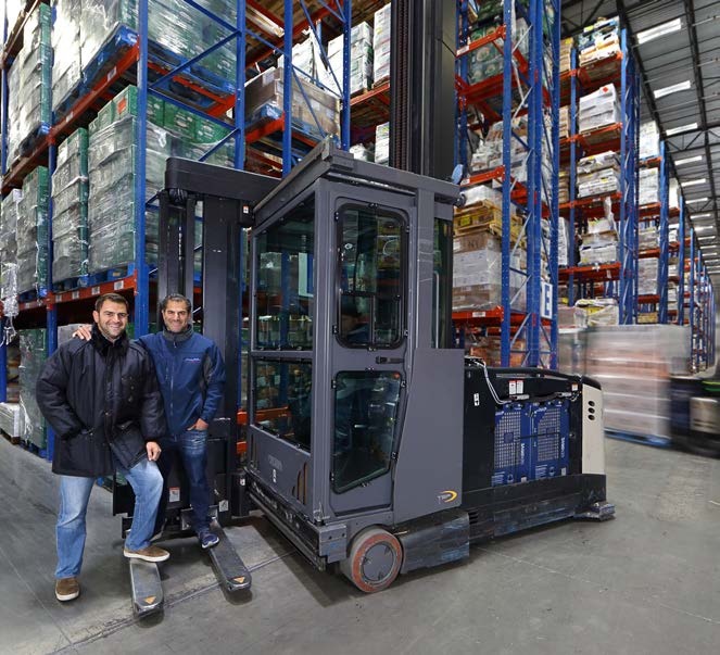 David and Michael Saoud beside a lift truck among pallet racks at FreezPak