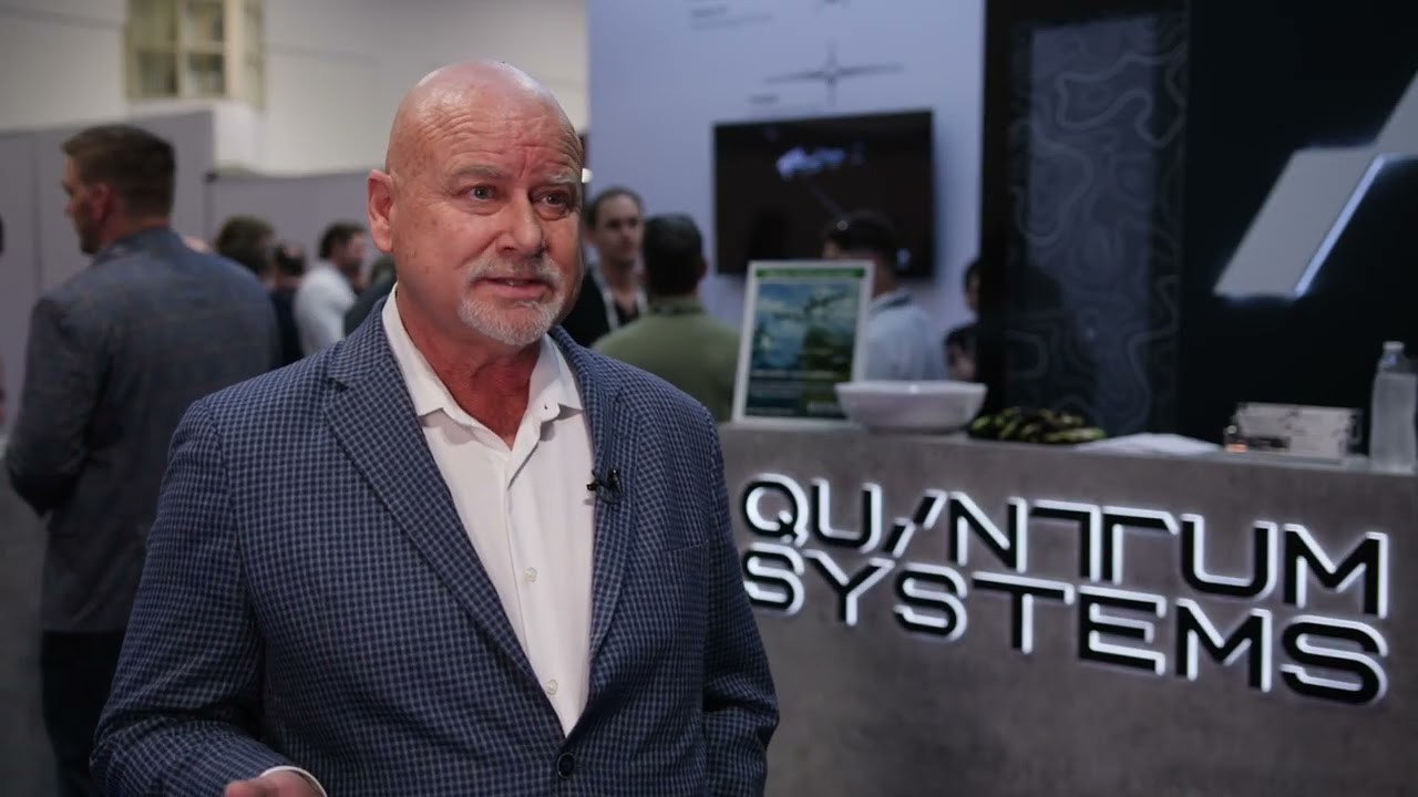 David Sharpin speaking at a Quantum Systems exhibition booth