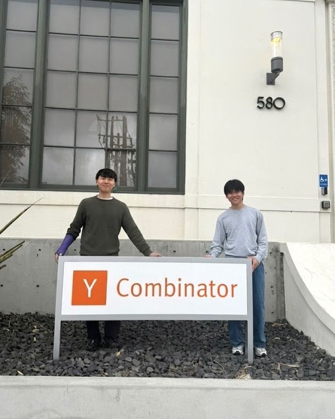 David Shijoon Bae and Michael Lin standing behind a Y Combinator sign