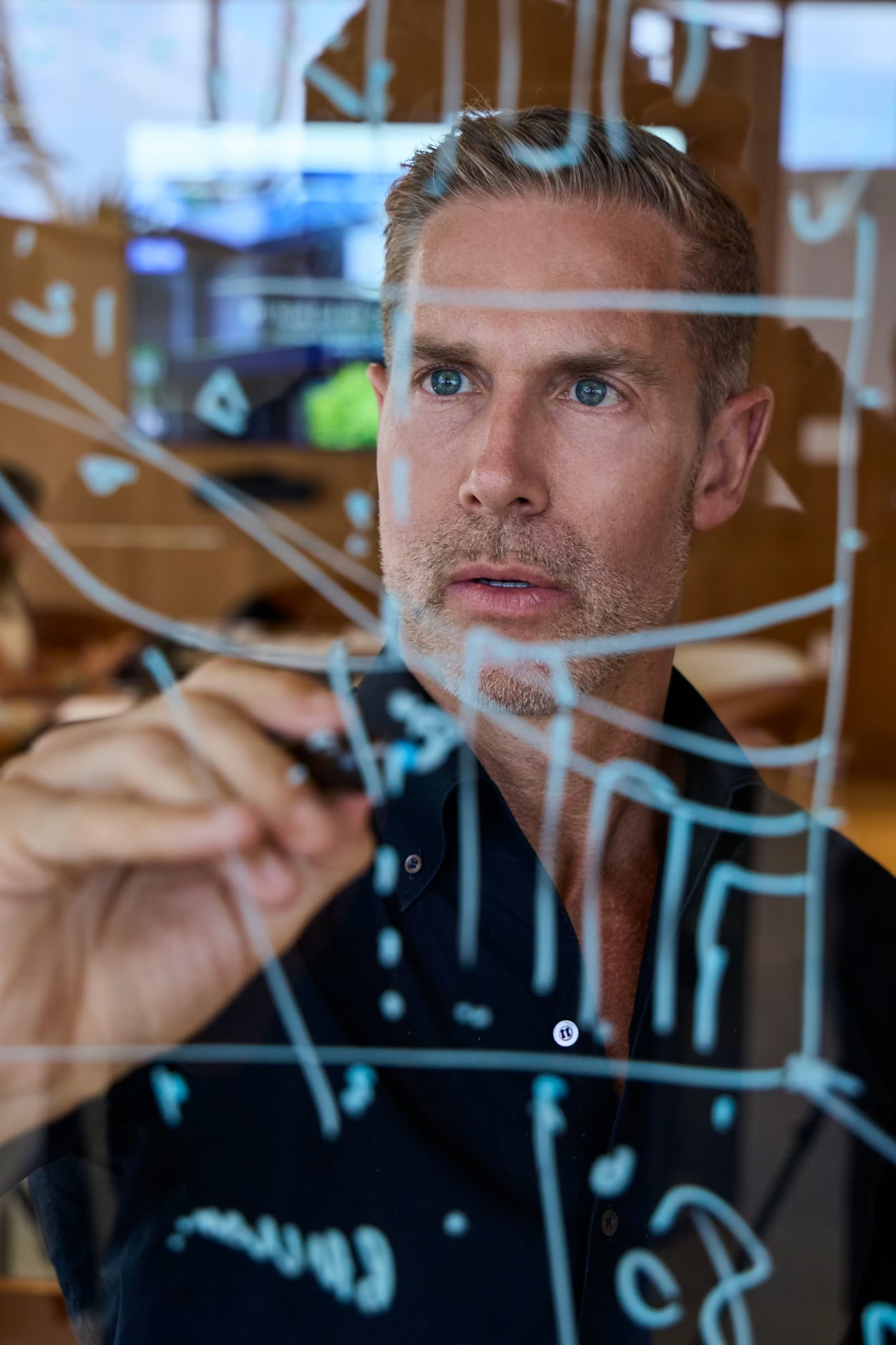 David Siddons working through diagrams on a transparent board