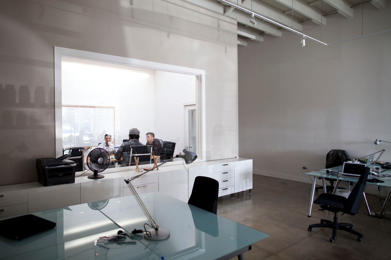 David Soloff and colleagues meeting behind a glass wall in the Premise office in 2013