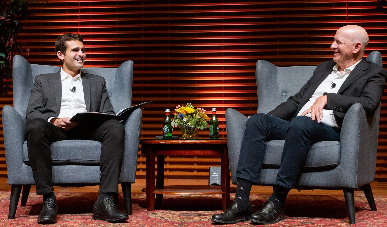 Mike Lewis, left, interviews David Solomon on stage at Stanford Graduate School of Business