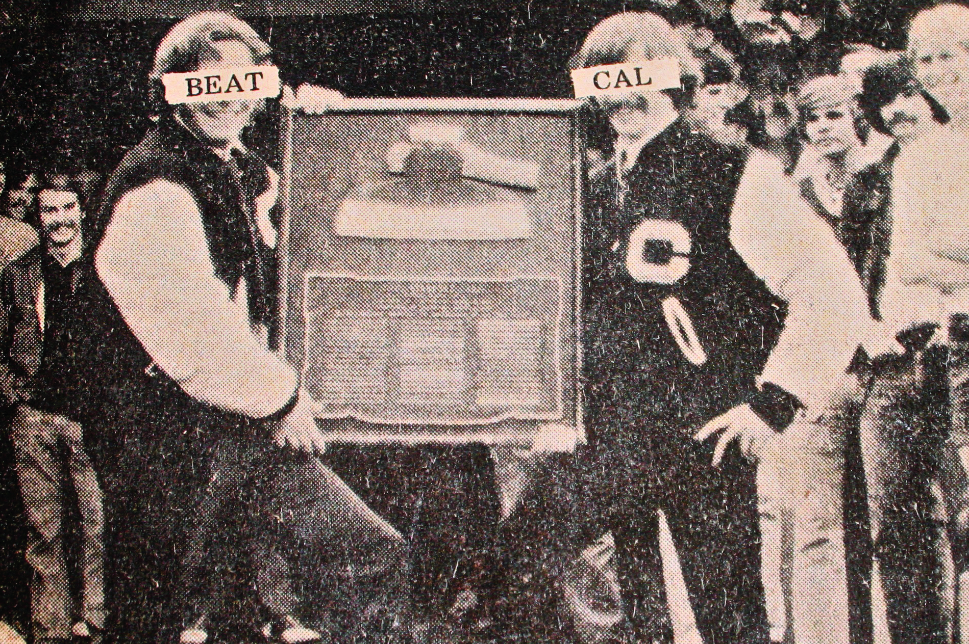 David Suliteanu at left and Tim Conway at right holding the Stanford Axe in 1973, with Beat Cal labels covering their eyes
