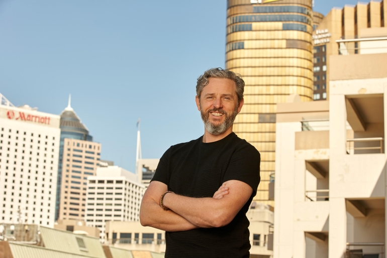 David Walsh standing outdoors among commercial buildings in Sydney