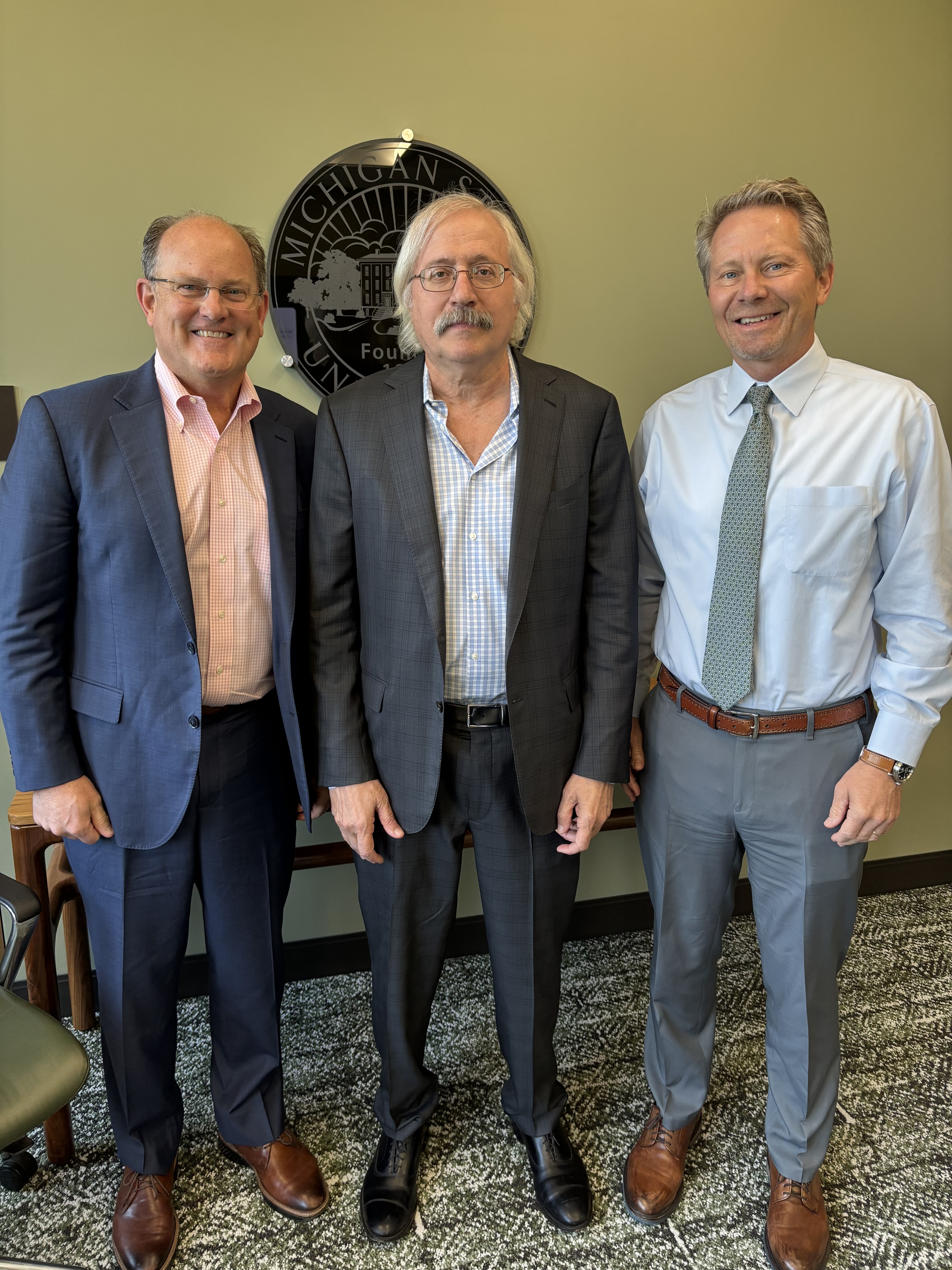David Washburn, Randolph Cowen, and Kevin Guskiewicz standing together at the MSU Research Foundation
