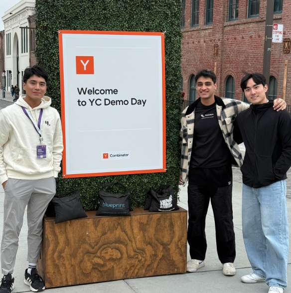 The YouLearn team standing beside a Welcome to YC Demo Day sign