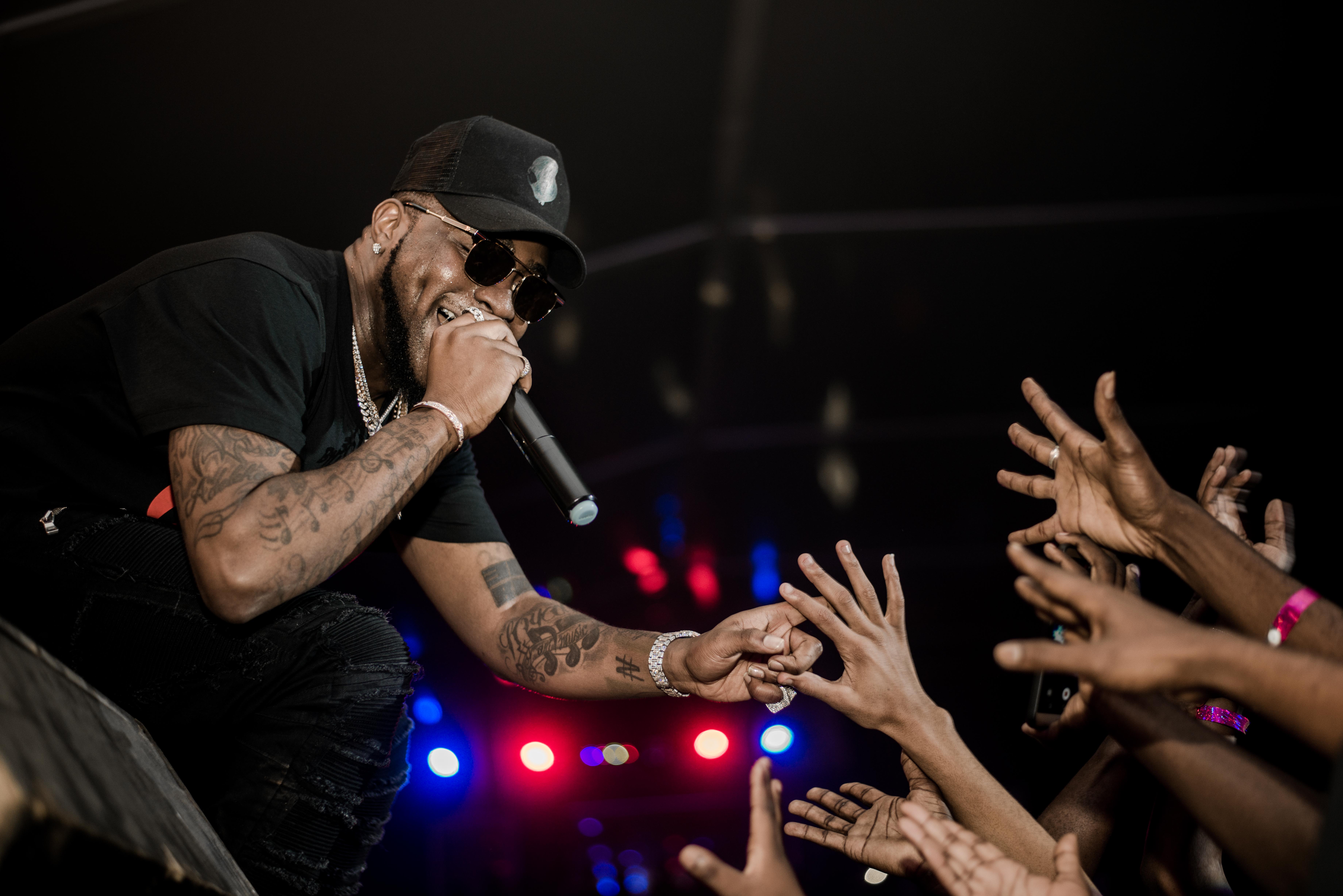 Davido performing onstage in Tanzania under blue light