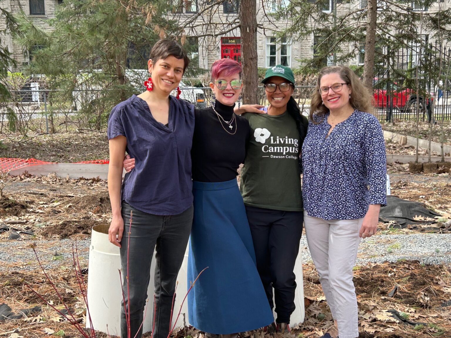Four members of Dawson College's Living Campus micro-forest team stand together on the campus grounds