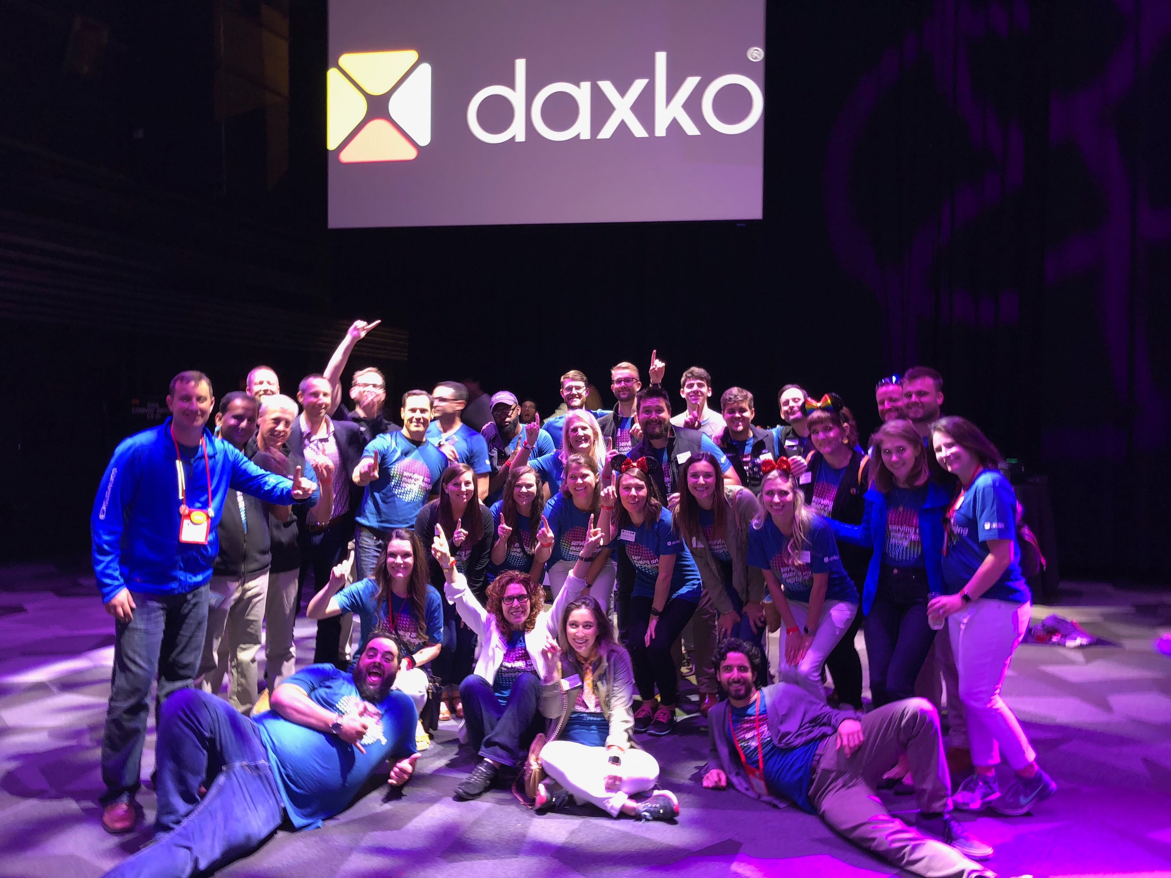 Daxko team members in matching blue shirts gathered at a YMCA General Assembly