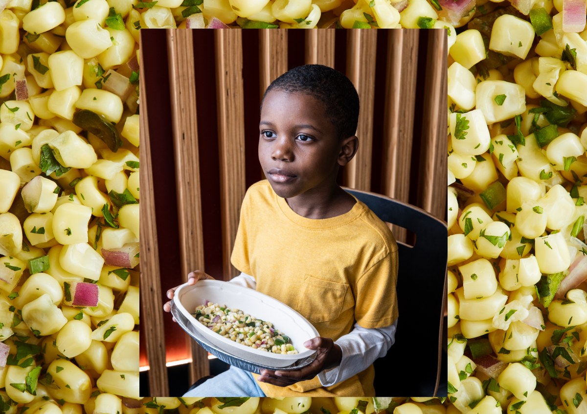 Tariq holding a Chipotle bowl against a background of corn salsa