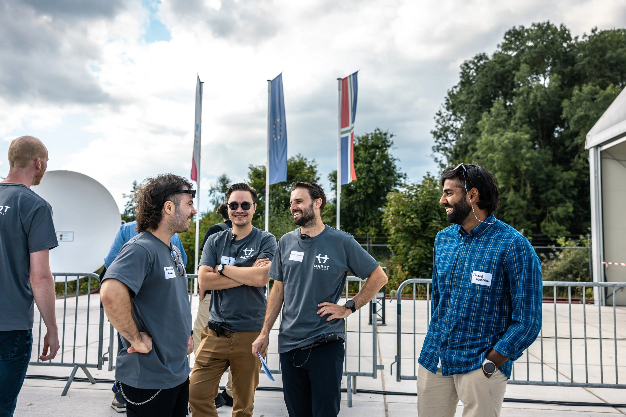 Hardt staff and attendees talk outdoors at a European Hyperloop Center event.