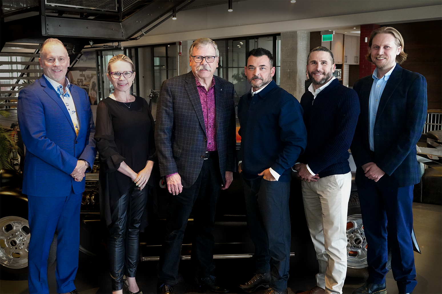 PBS Systems and Dealer Image Pro leaders standing together after the acquisition
