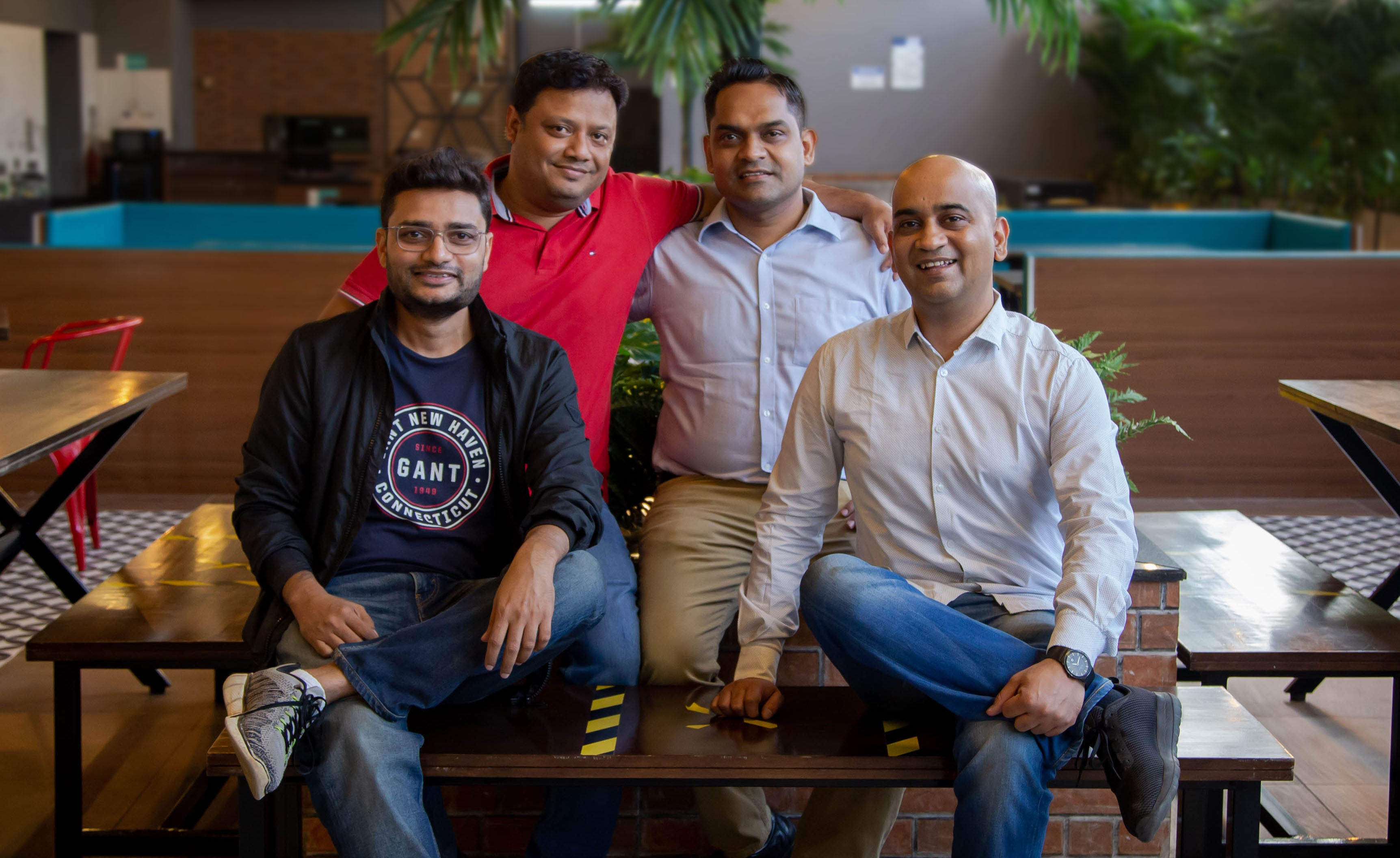 DealShare’s four co-founders pose together in an office lounge