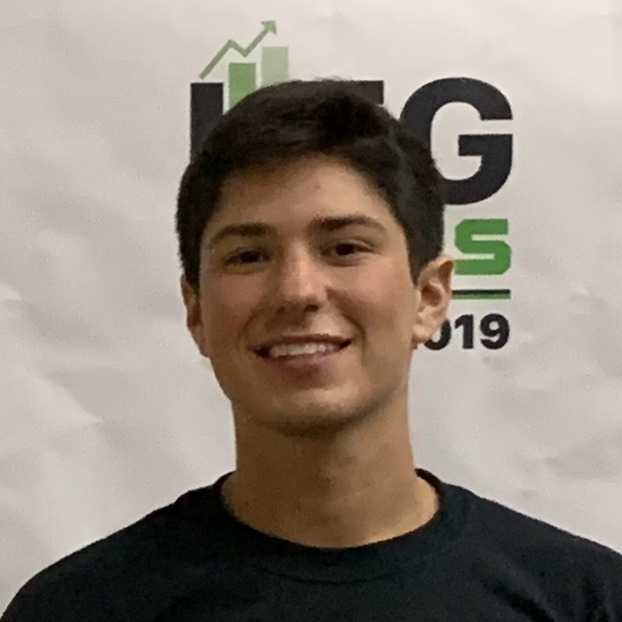 Dean Zimberg smiling in front of an LFGhacks 2019 backdrop