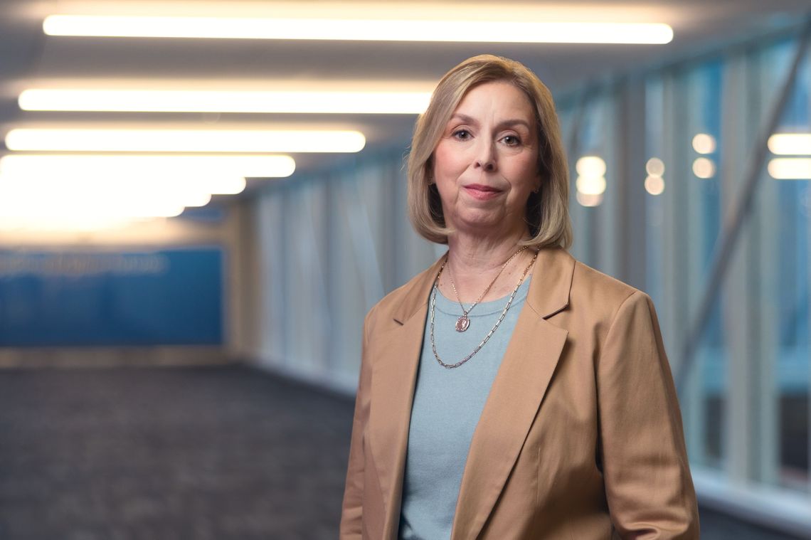 Deanna Strable standing in a Principal office hallway