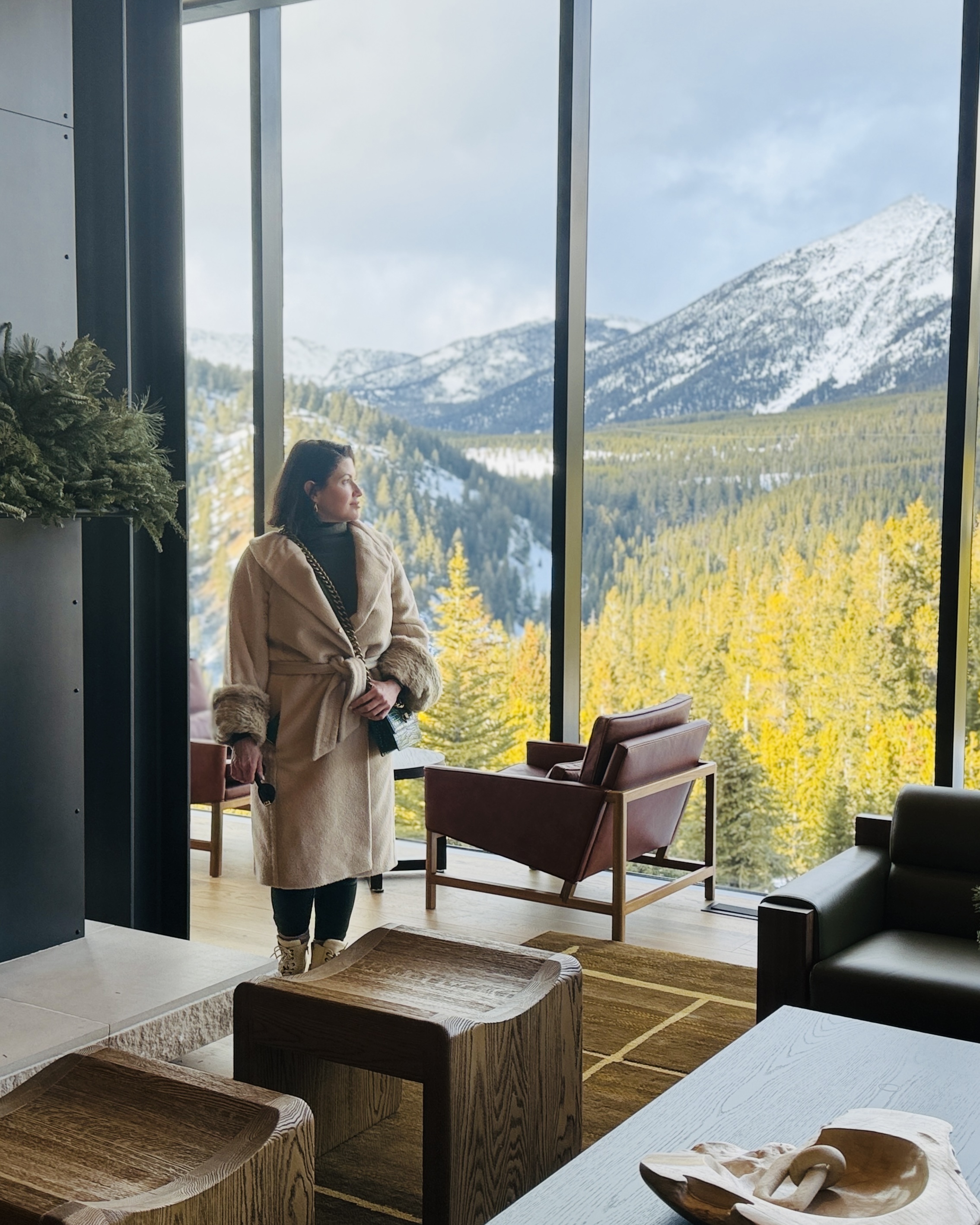 Deb Lewis standing before a broad snowy mountain view in Big Sky, Montana