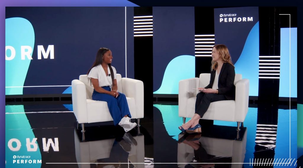 Debbie Umbach seated on stage in conversation with Simone Biles at Dynatrace Perform 2022