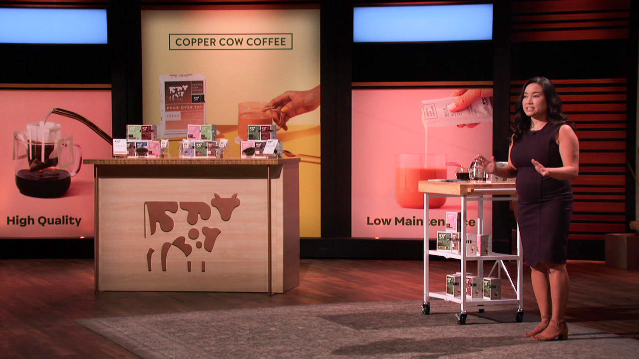 Debbie Wei Mullin presenting Copper Cow Coffee beside product displays on Shark Tank