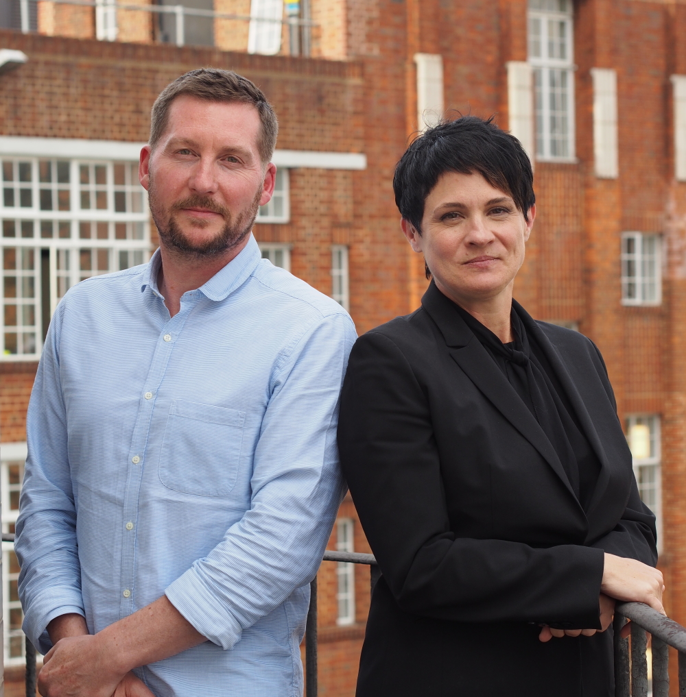 Andy Emery and Deborah Kirkham standing outside a brick building in London