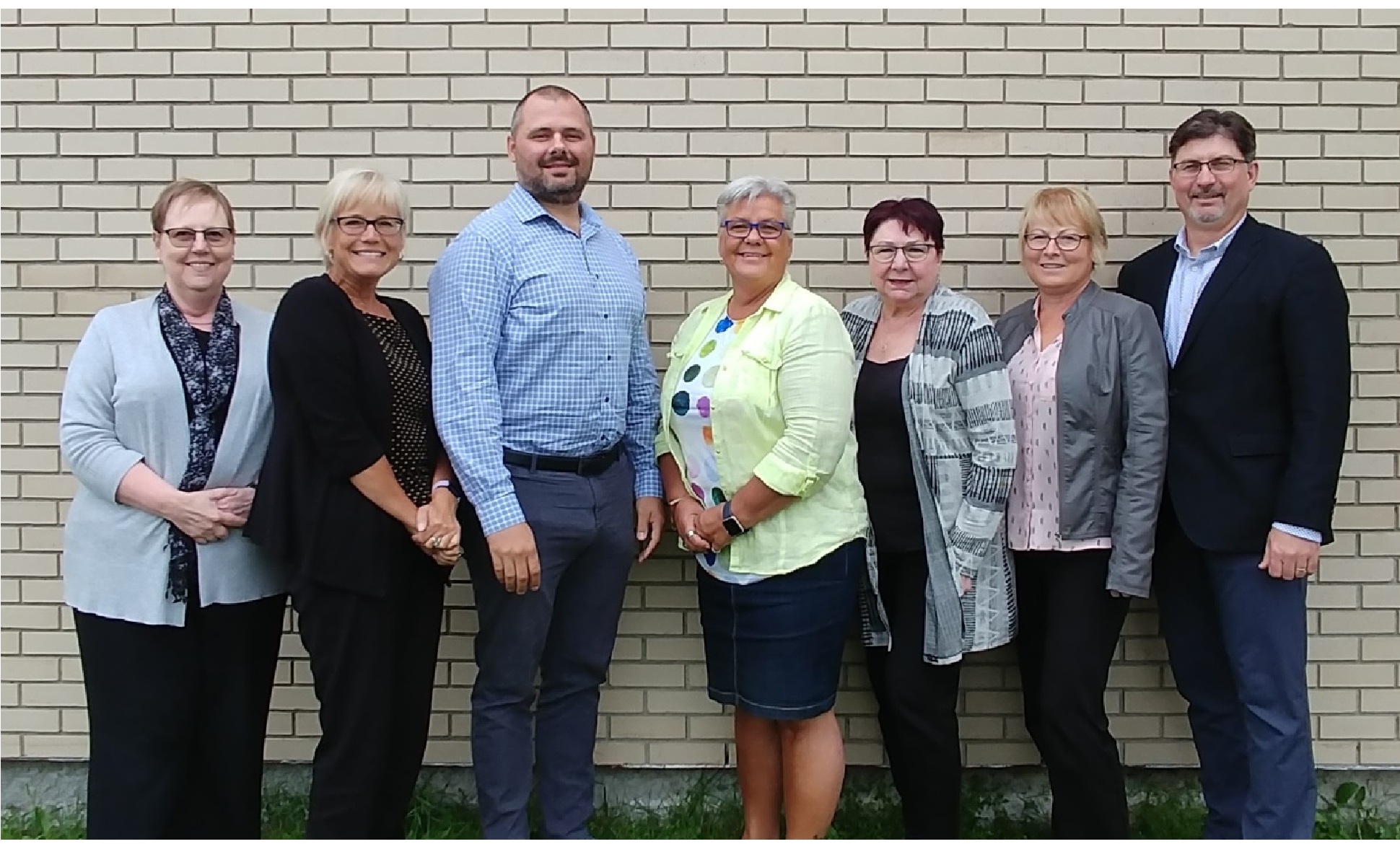 Seven members of the Northern Health Region executive leadership council standing together outdoors, with Deborah Mabin at far left