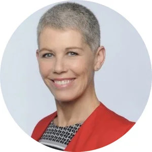 Deb Noller in a red jacket, photographed for a professional profile