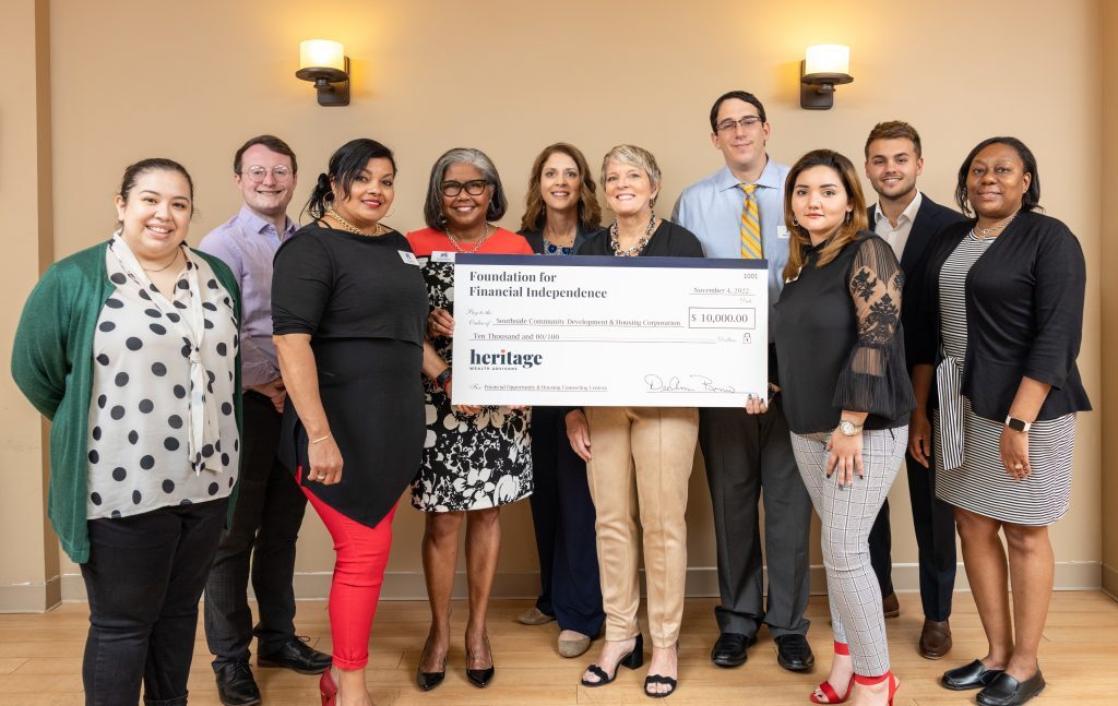 Dee Ann Remo and representatives of Heritage and Southside Community Development and Housing Corporation at a 2022 grant presentation