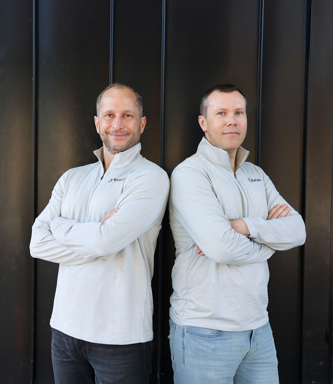 Defakto co-founders Danny Oliveri and Eli Nesterov standing back to back