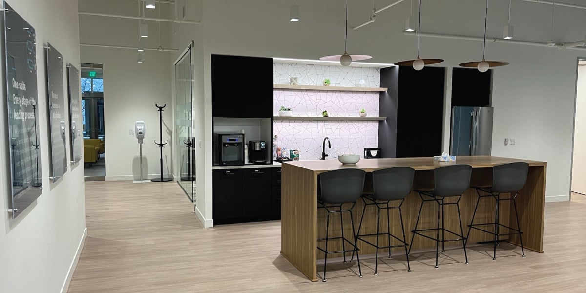 A kitchen and seating area at defi SOLUTIONS’ Westlake office