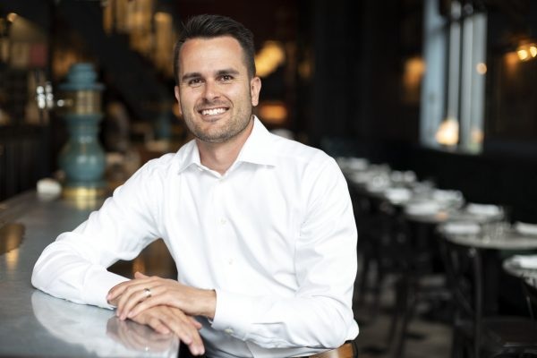 Degreed co-founder David Blake seated at a counter