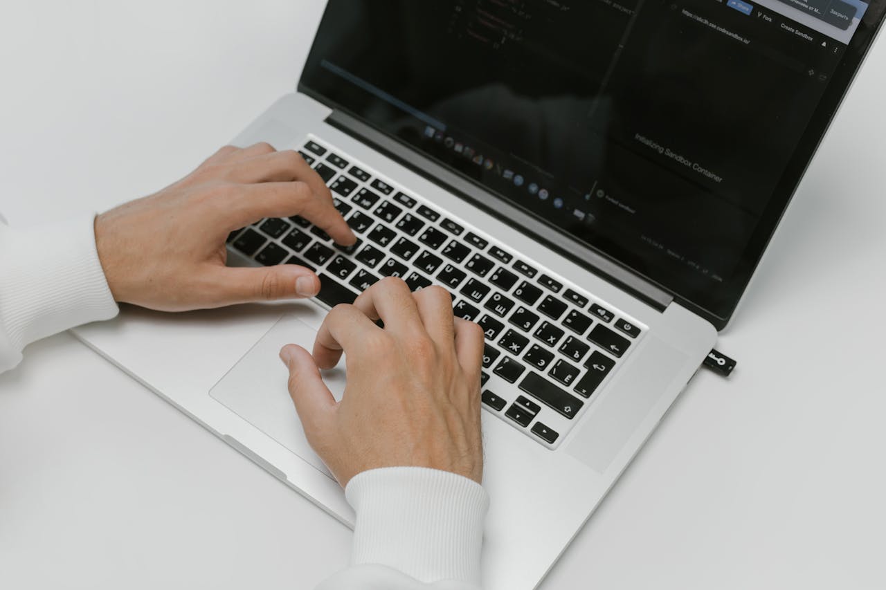 Hands working on a laptop, from Delesign's account of its 2020 acquisition