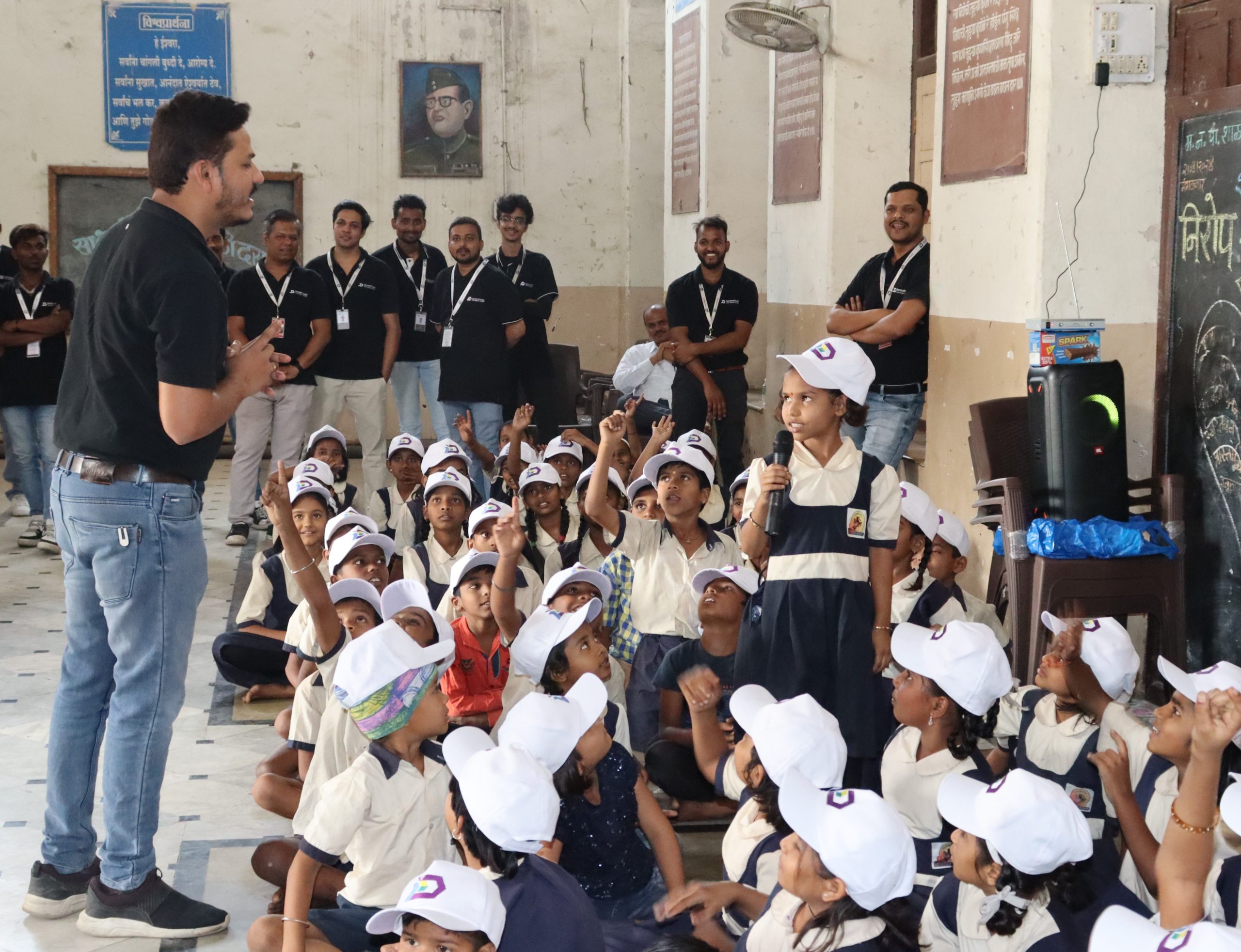 Company representatives and schoolchildren during a gathering pictured on Demand Media BPM’s About page